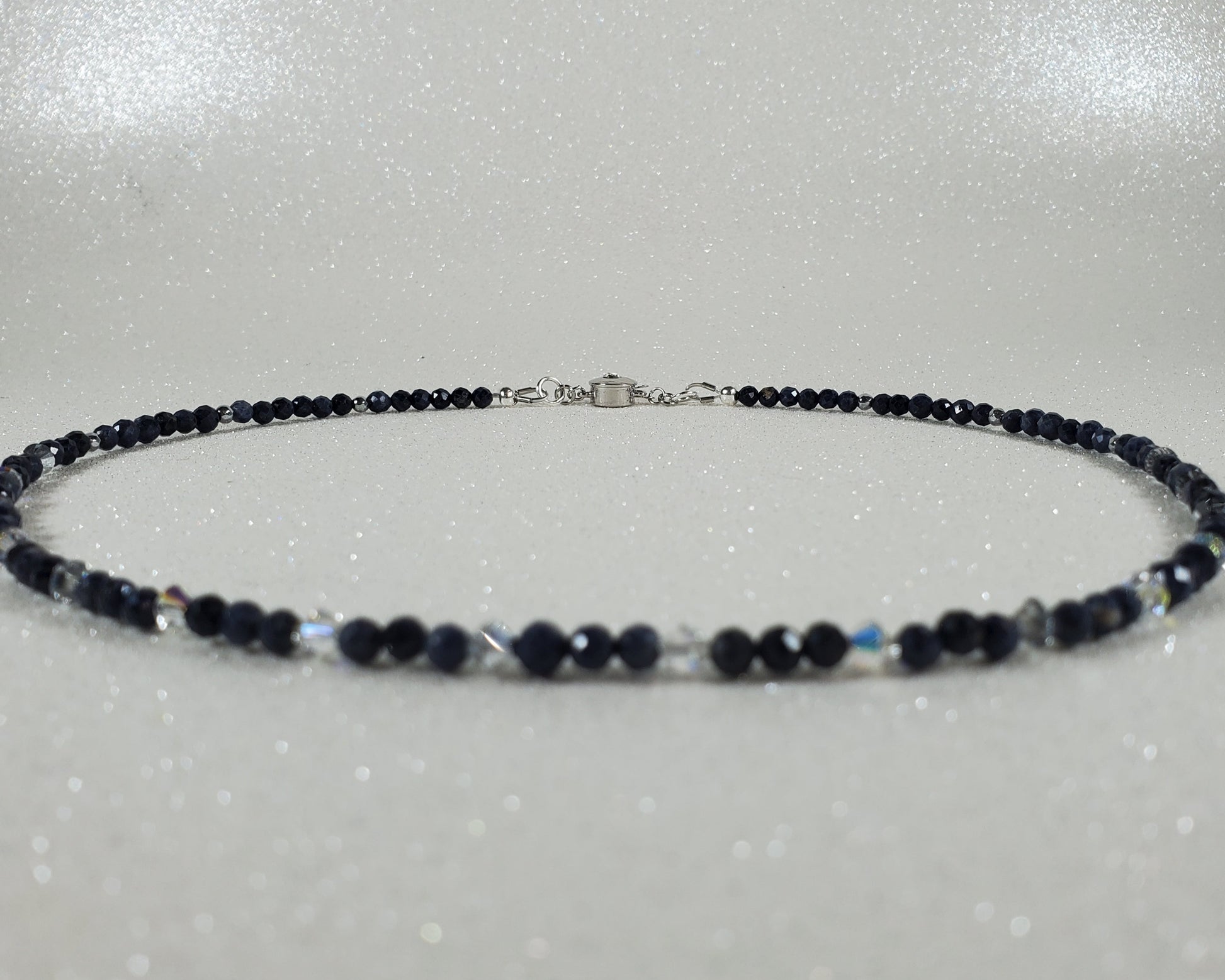 Necklace with blue beads on a gray background