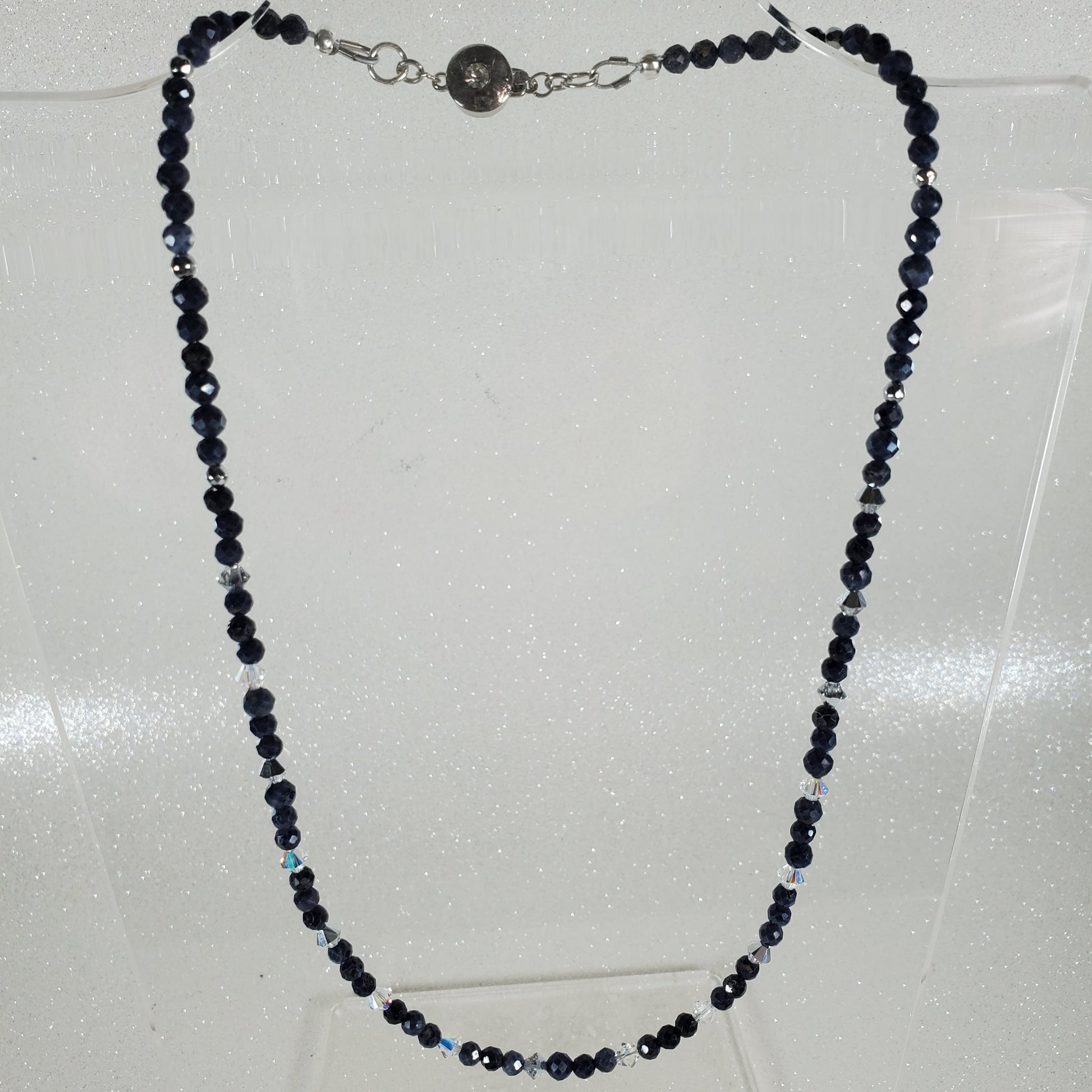 Necklace with blue beads on a light gray background