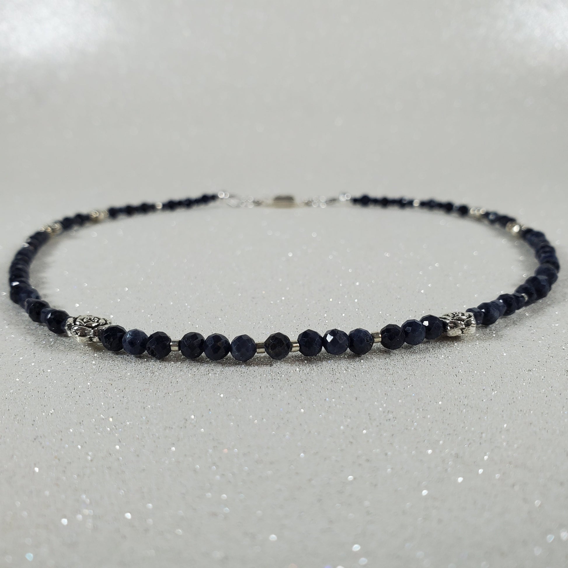 Necklace with dark blue beads on a white background