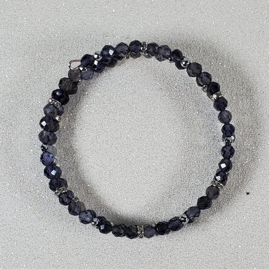 Blue beaded bracelet on a light gray background