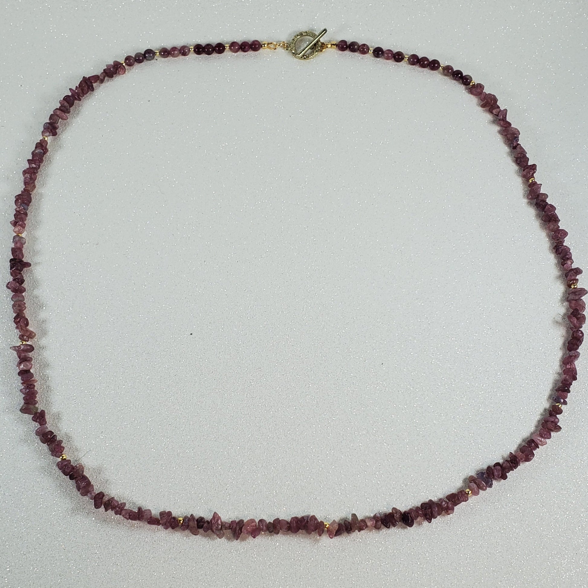 Necklace with red beads on a white surface