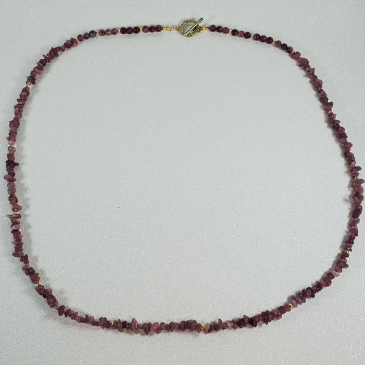 Necklace with red beads on a white surface