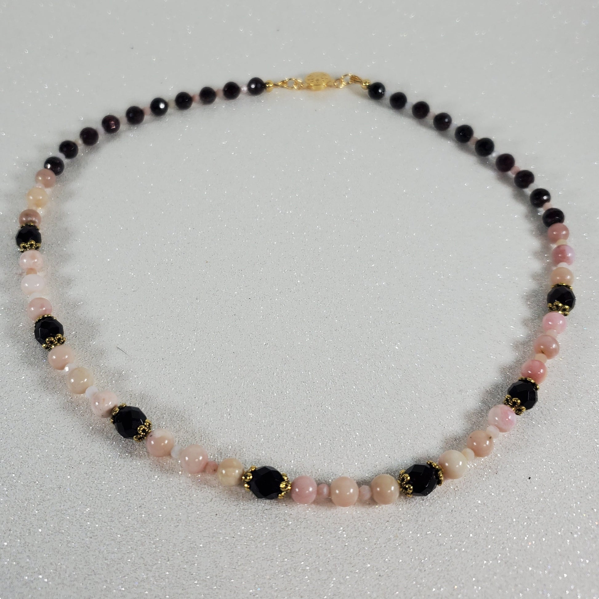 Necklace with multicolored beads on a light gray background