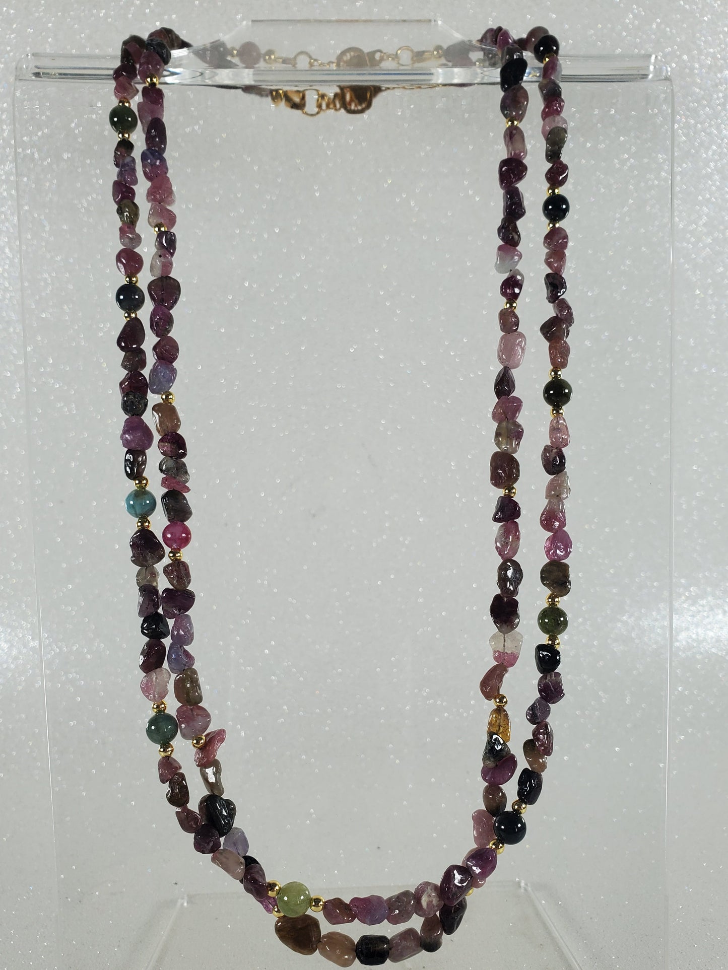 Necklace with multicolored gemstones on a white background