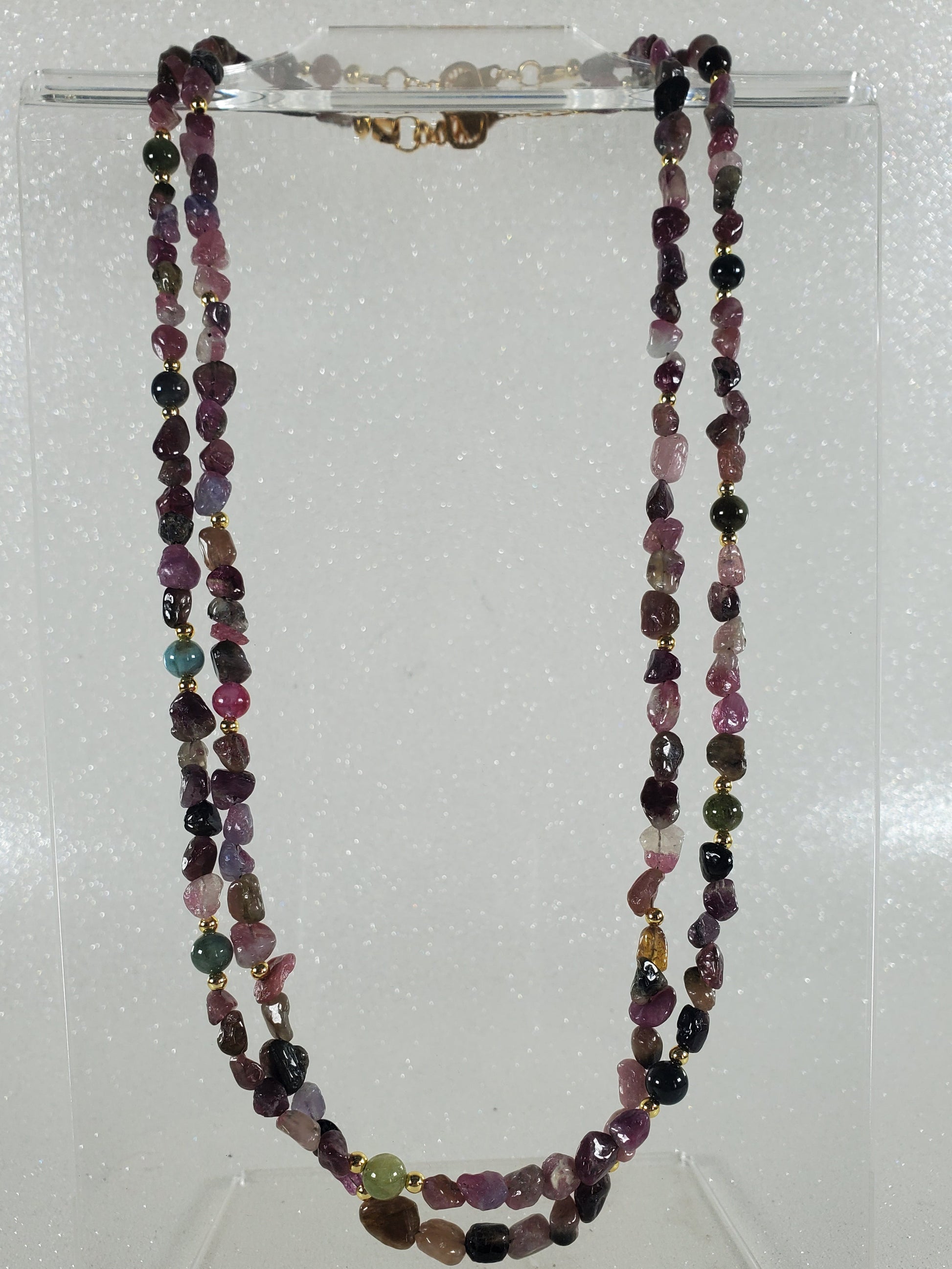 Necklace with multicolored gemstones on a white background
