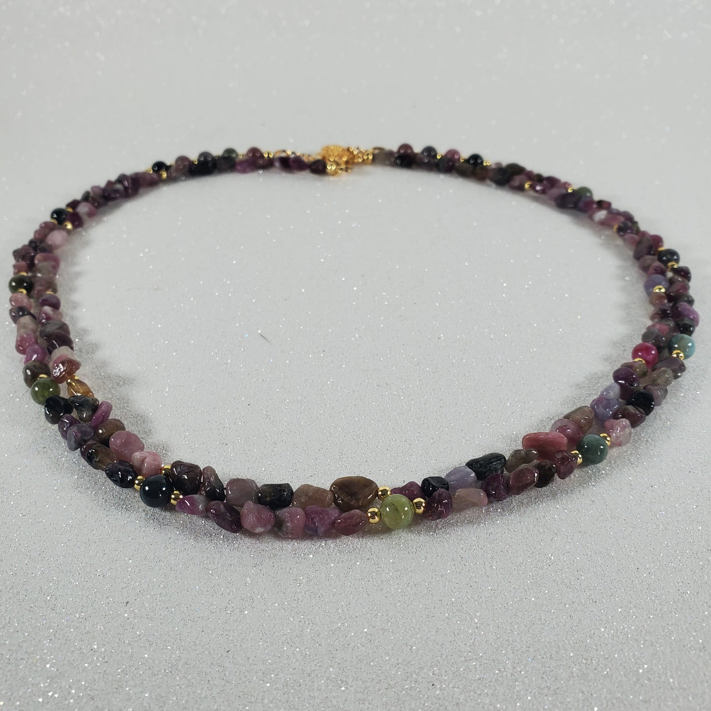 Necklace with multicolored beads on a light gray background
