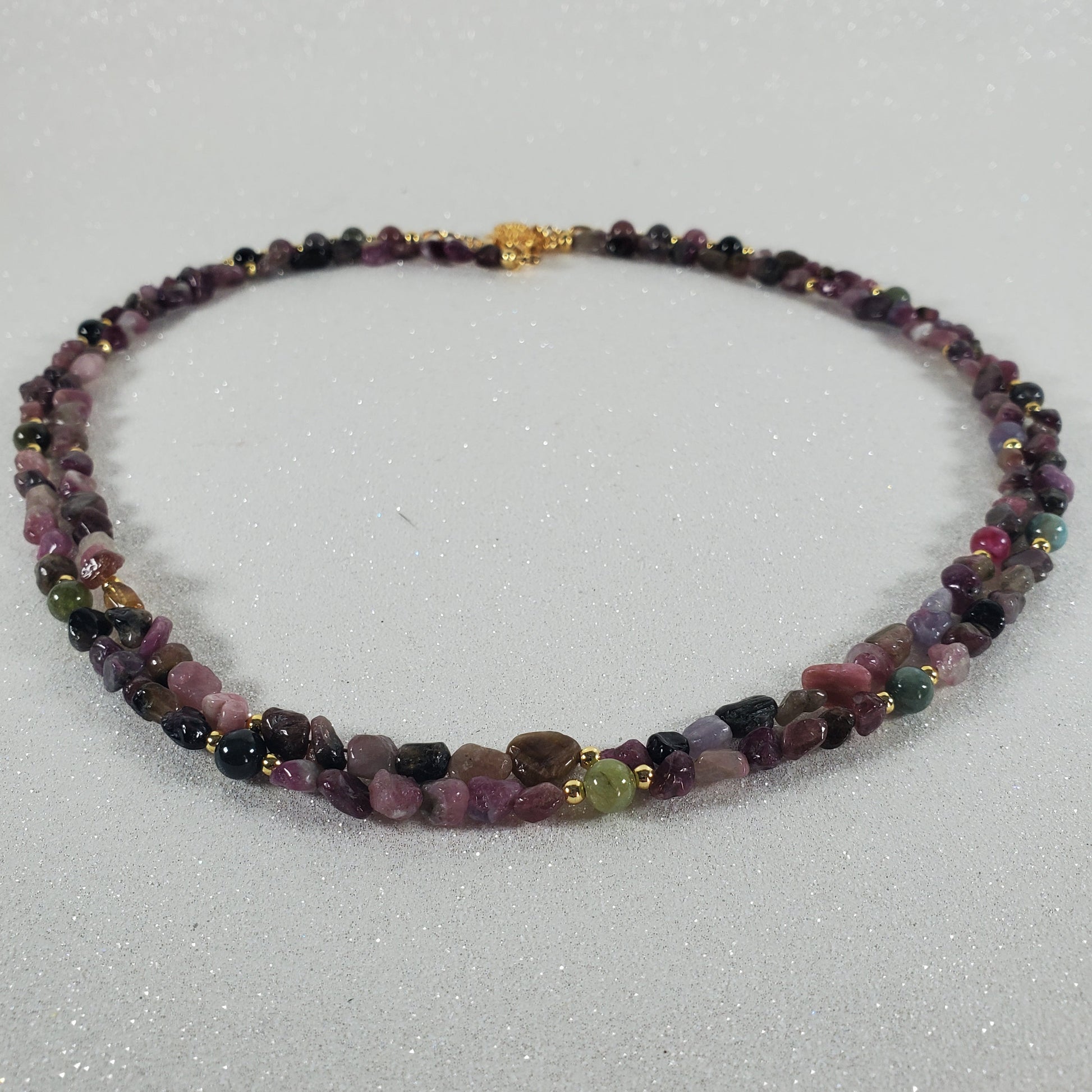 Necklace with multicolored beads on a light gray background