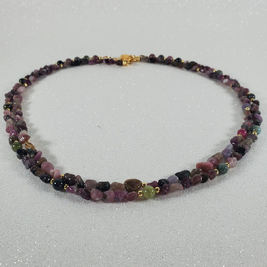 Necklace with multicolored beads on a light gray background