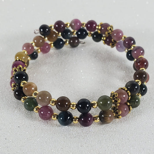 Multicolored beaded bracelet on a light gray background