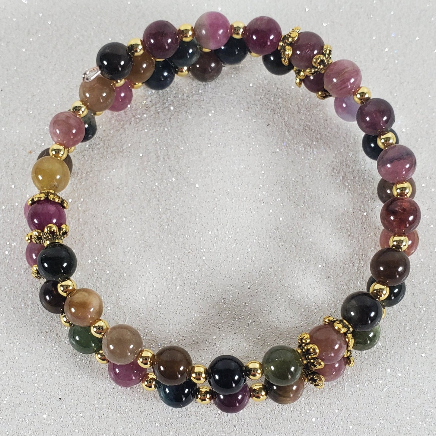 Multicolored beaded bracelet on a light gray background