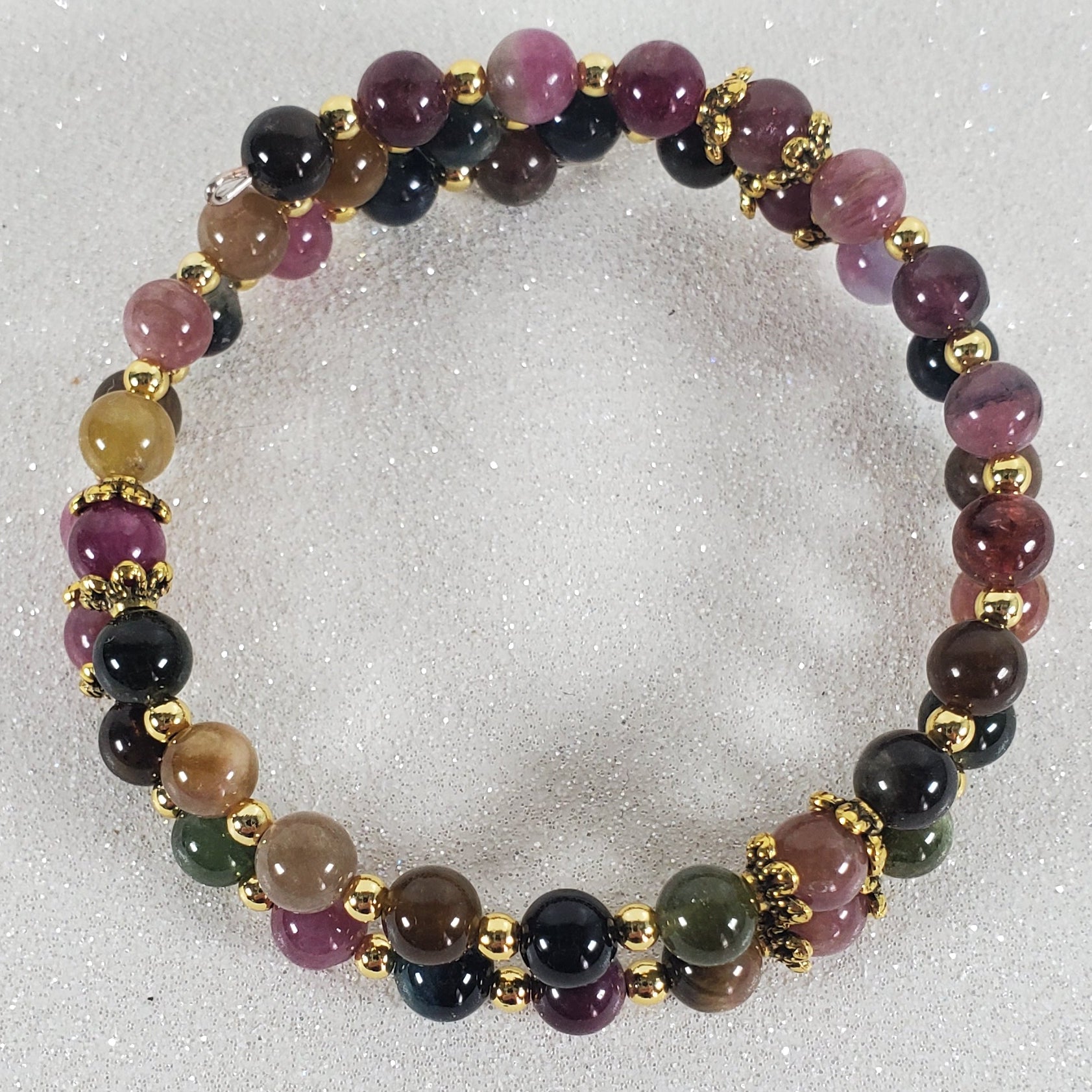 Multicolored beaded bracelet on a light gray background