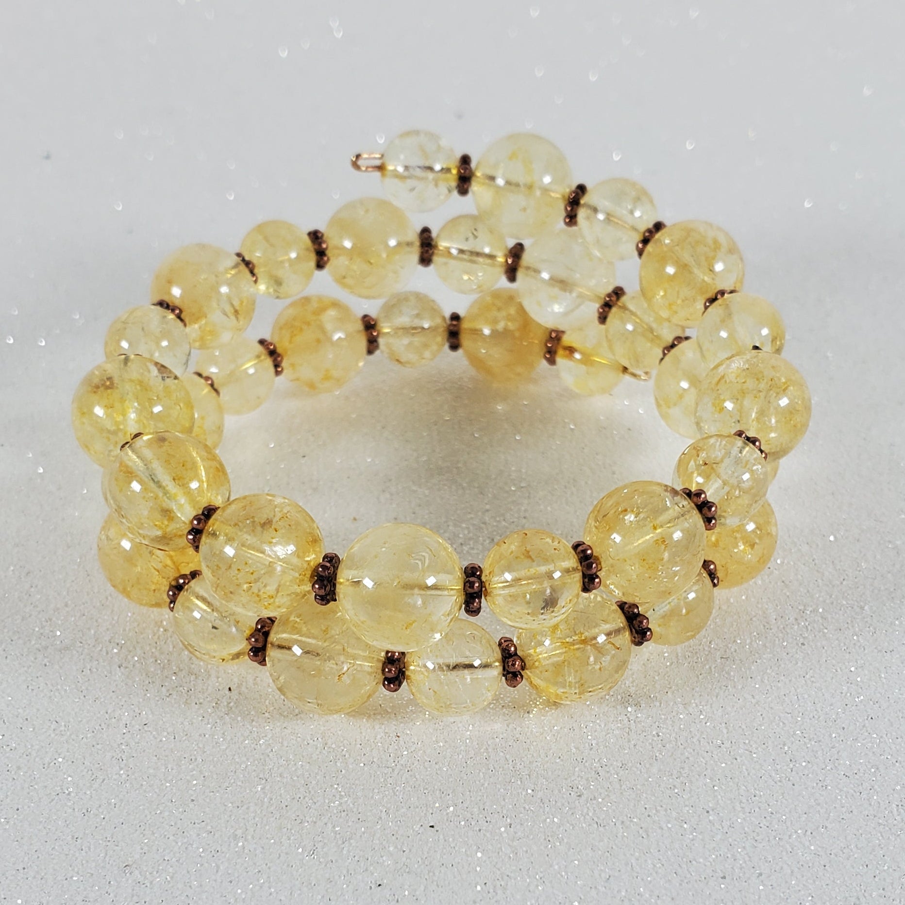 Beaded bracelet with yellow beads on a gray background