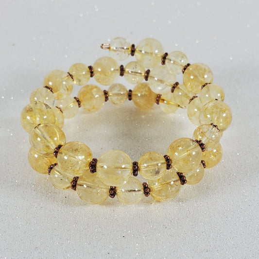 Beaded bracelet with yellow beads on a gray background