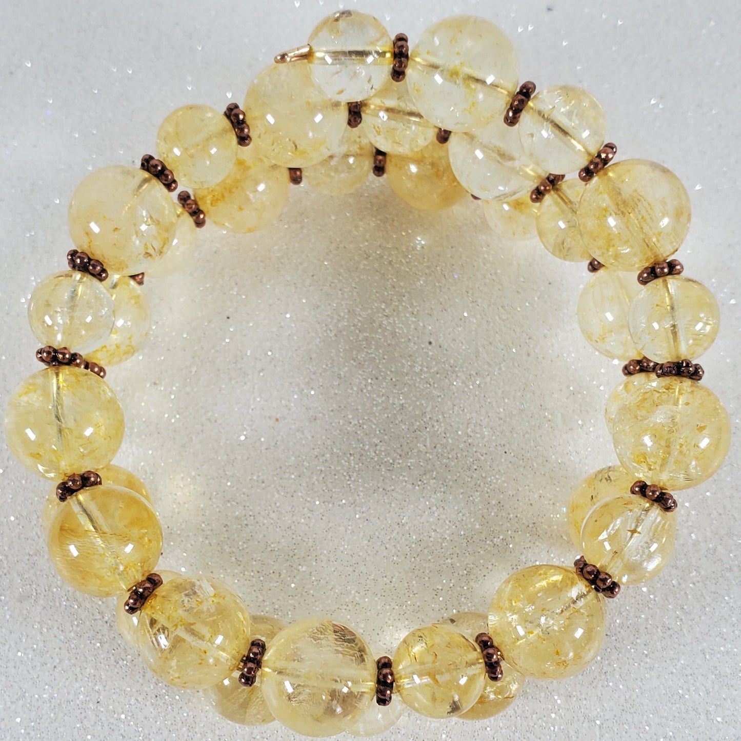 Yellow beaded bracelet on a light gray background