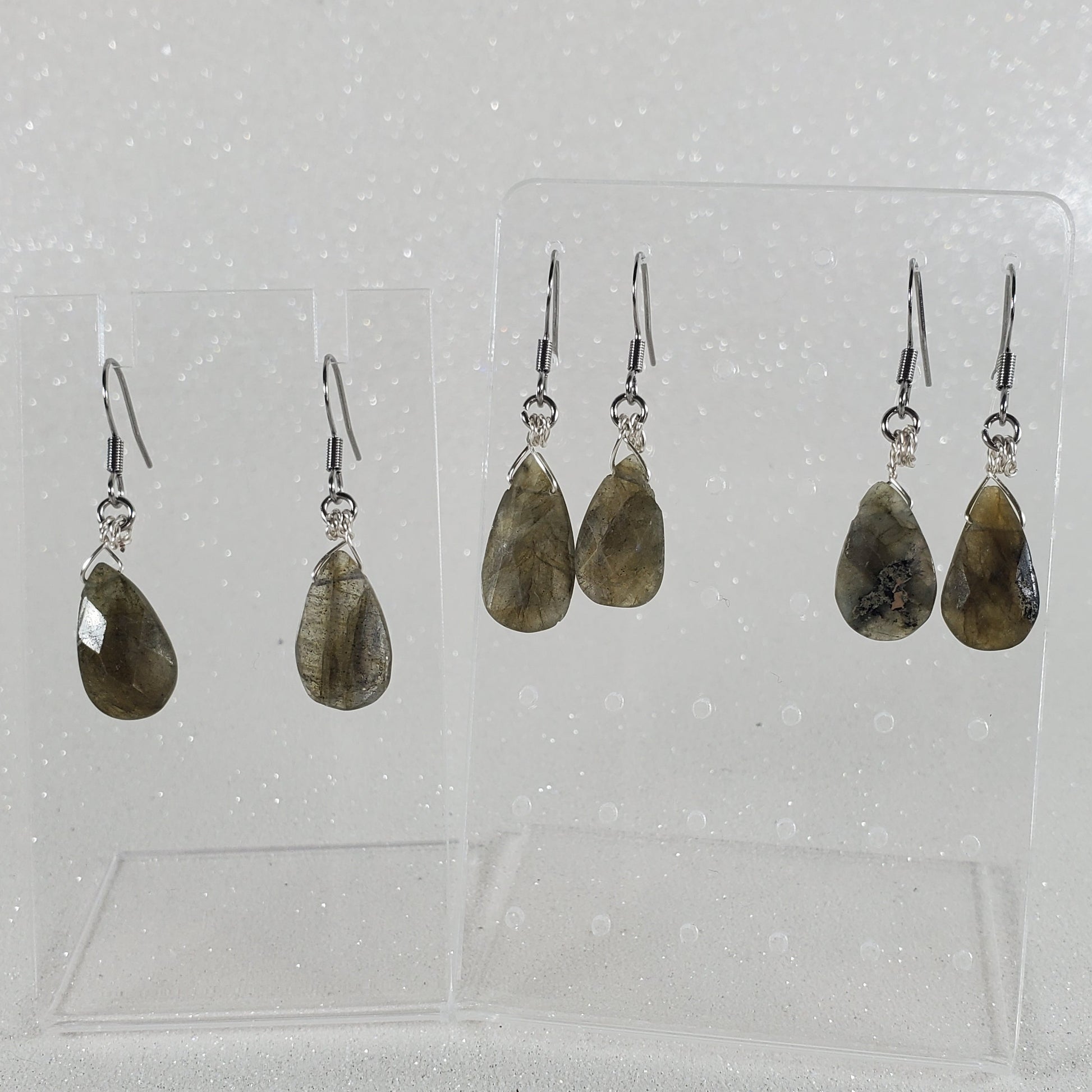 Set of earrings on a clear card with a white background