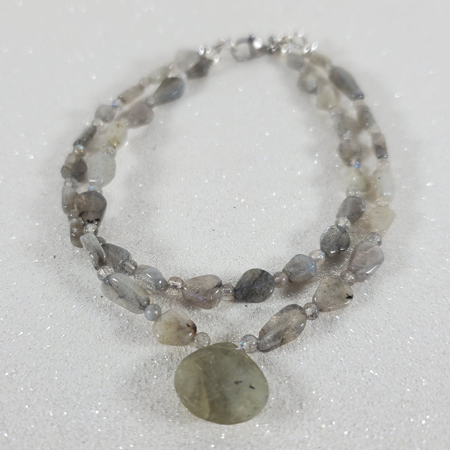 Beaded bracelet with a large central stone on a white background