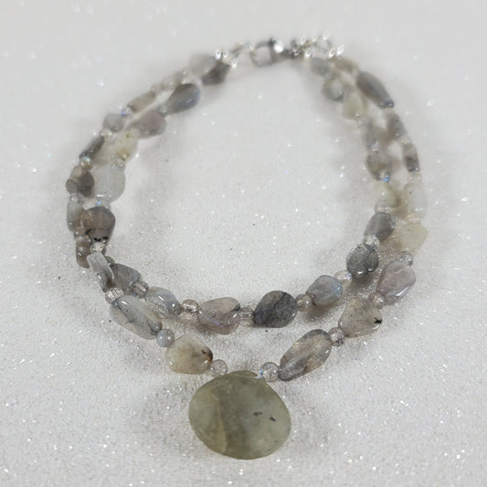 Beaded bracelet with a large central stone on a white background