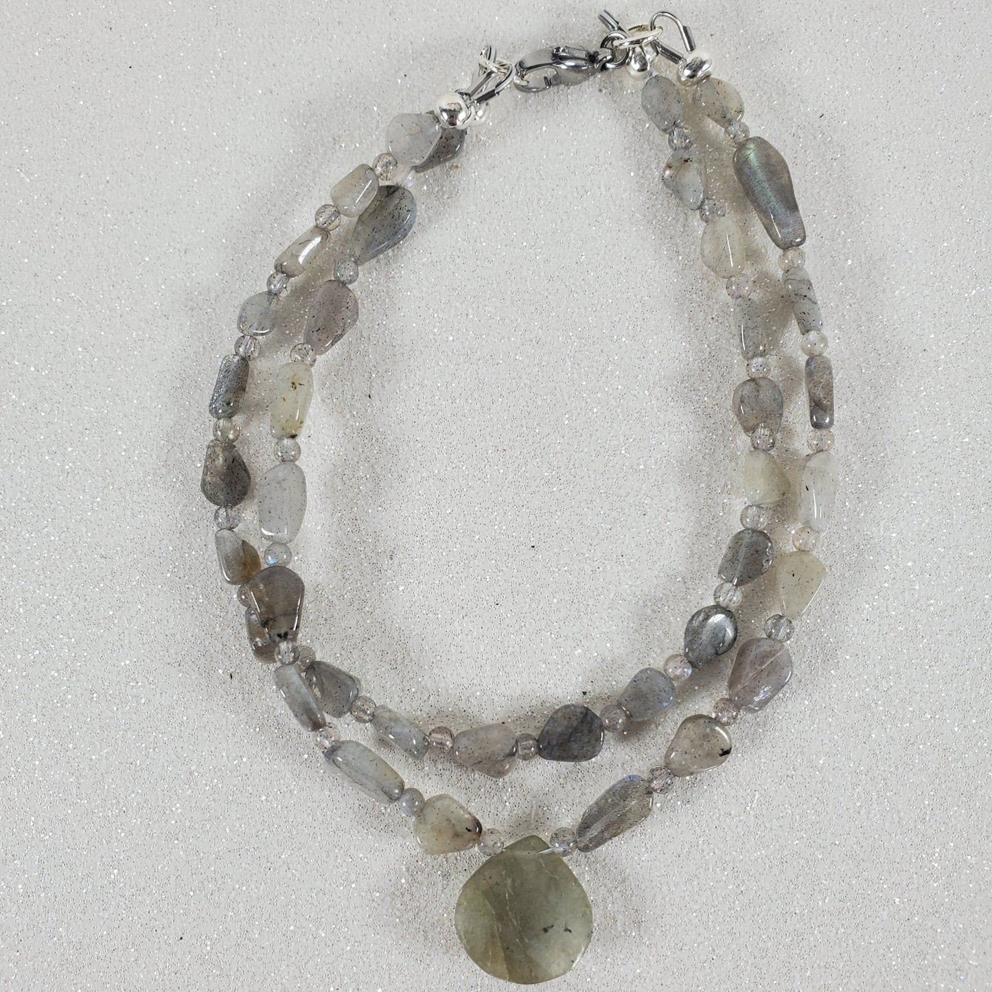 Beaded bracelet with natural stones on a light gray background