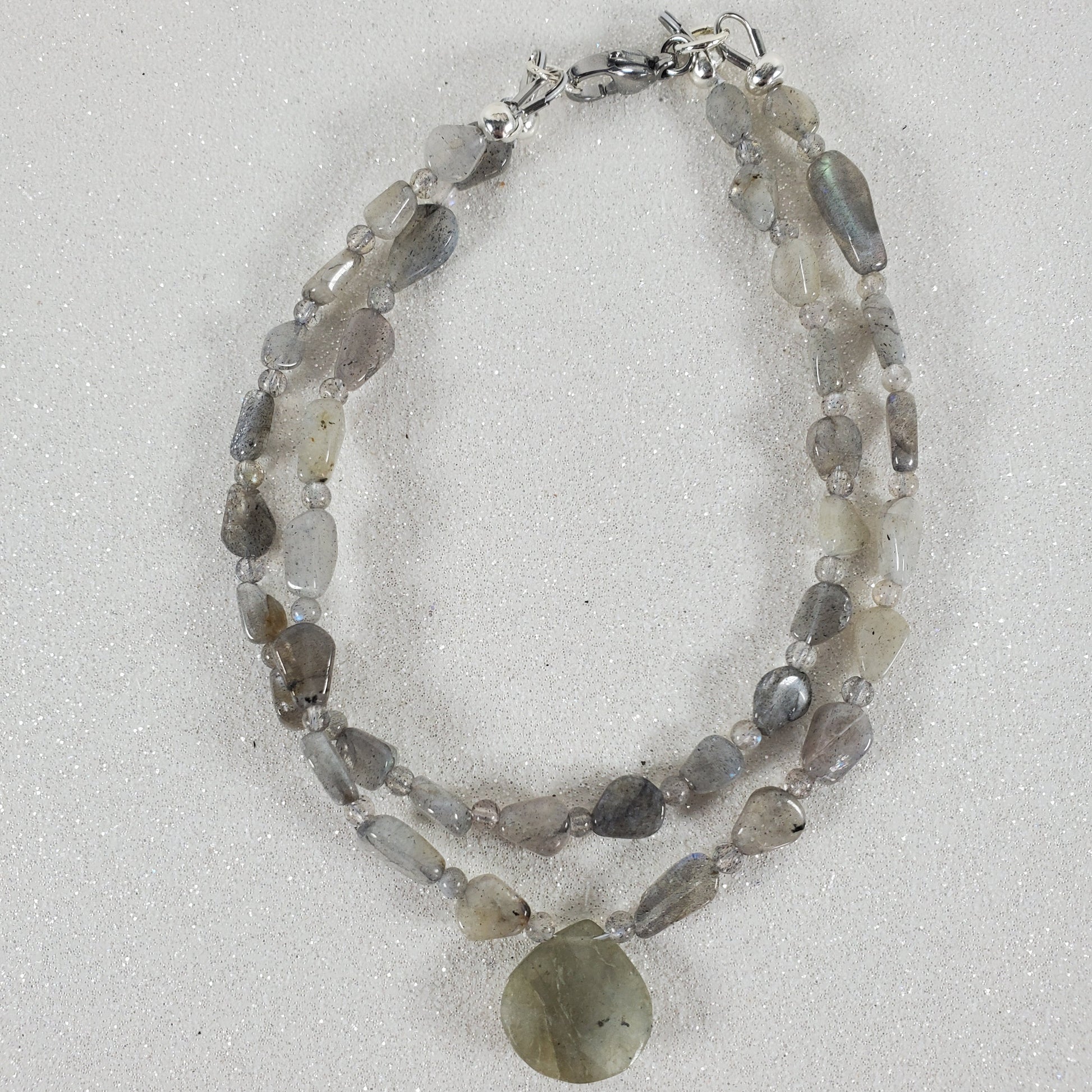 Beaded bracelet with natural stones on a light gray background