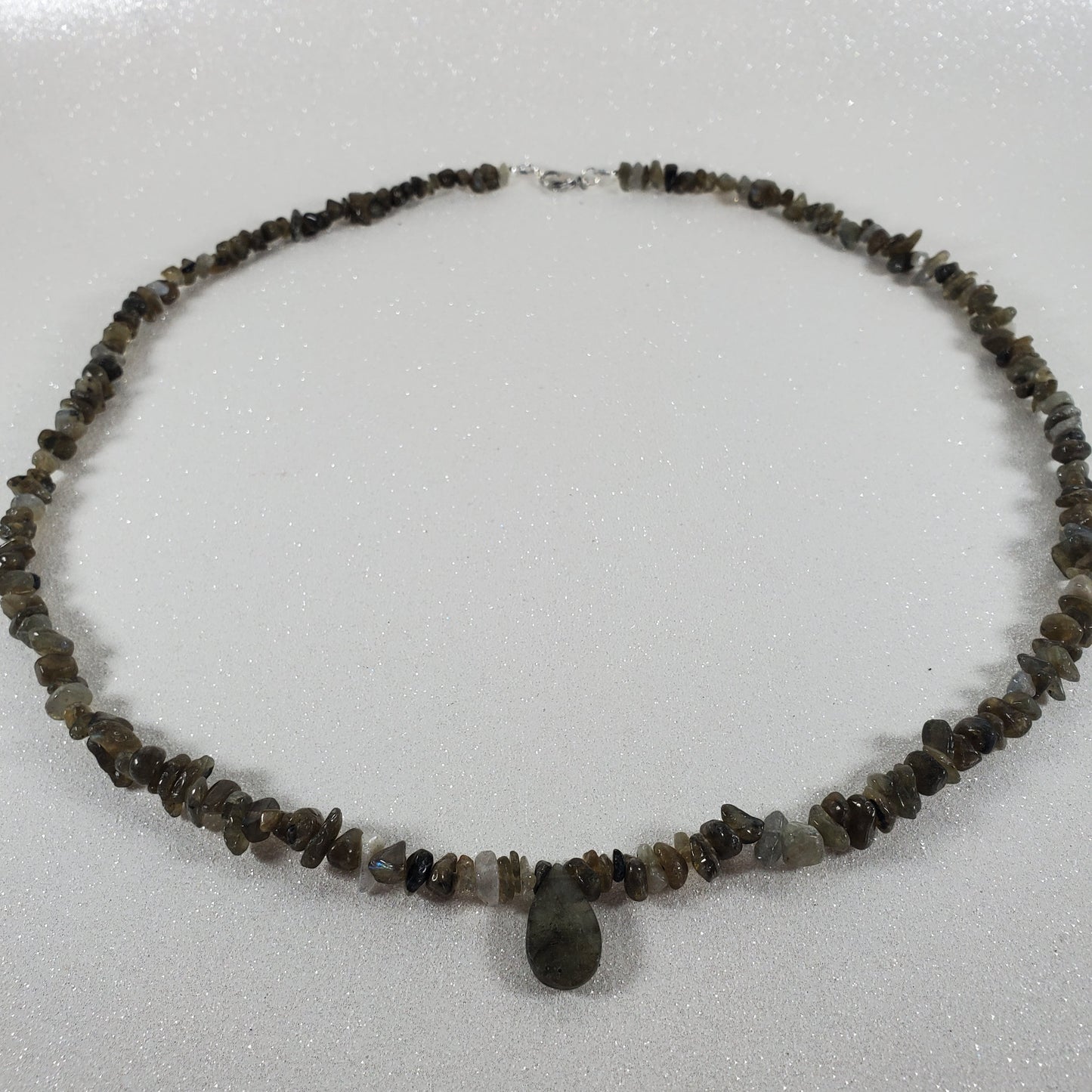 Necklace with small beads on a light gray background