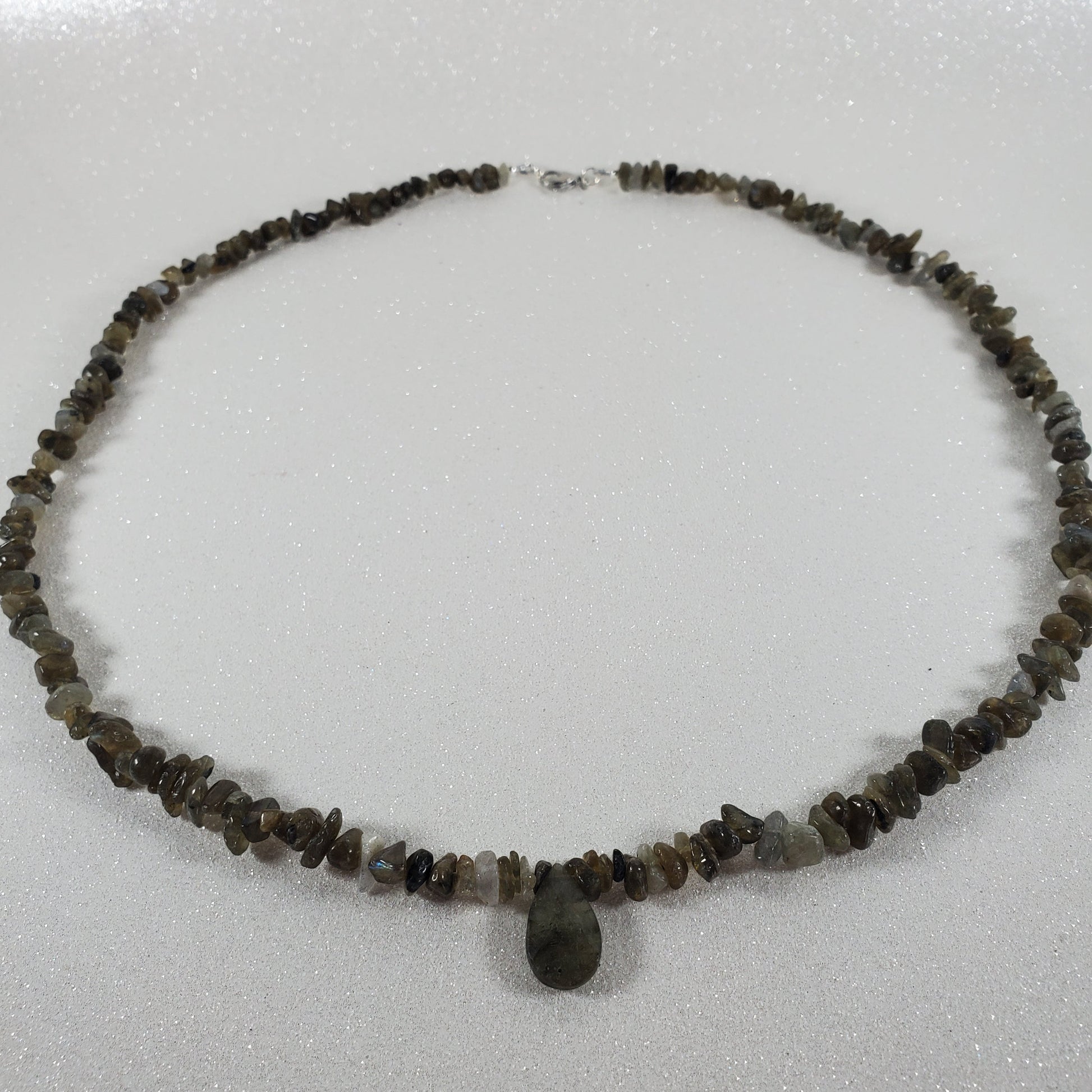 Necklace with small beads on a light gray background