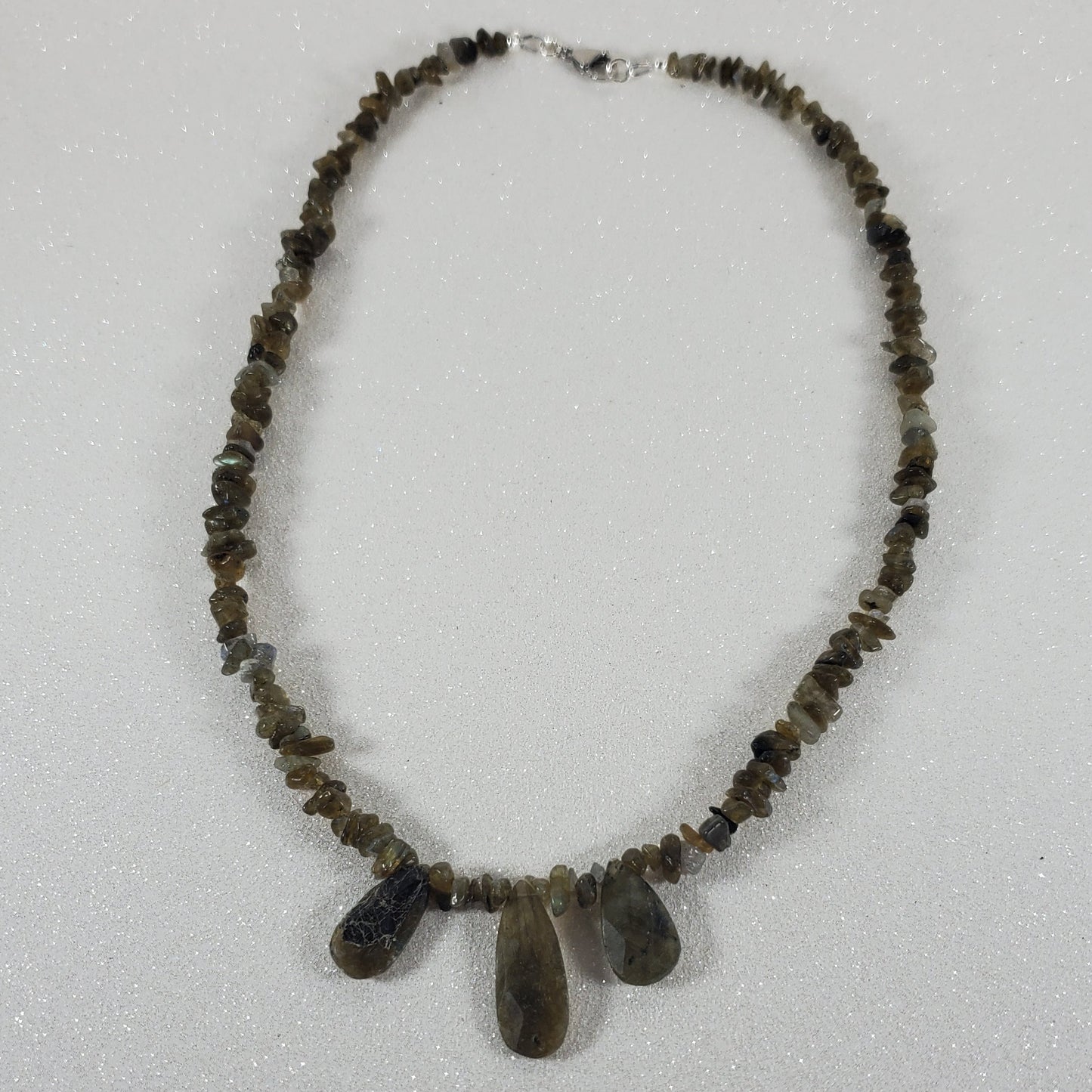 Beaded necklace with a lobster claw clasp on a white background