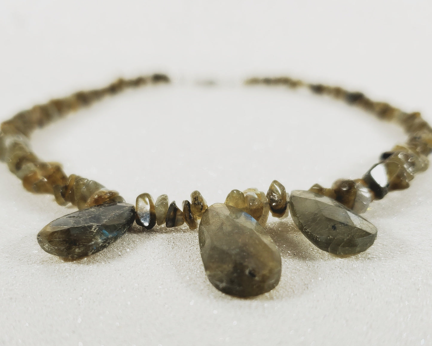 Necklace with teardrop-shaped beads on a white background