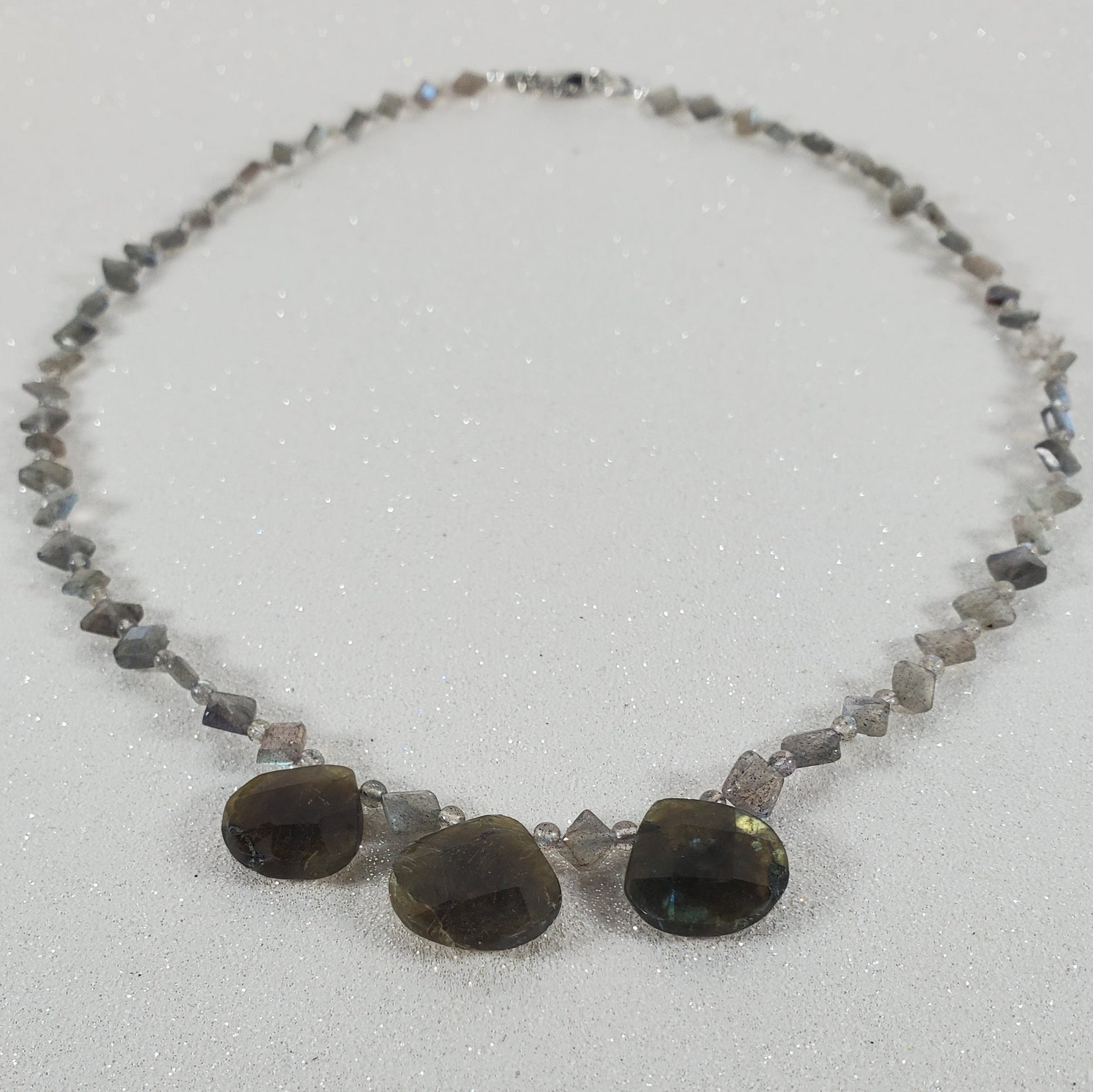 Necklace with stones on a light gray background