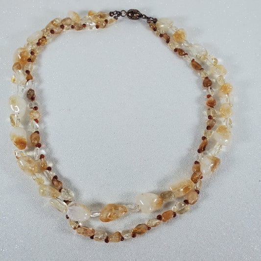 Necklace with multicolored beads on a light gray background