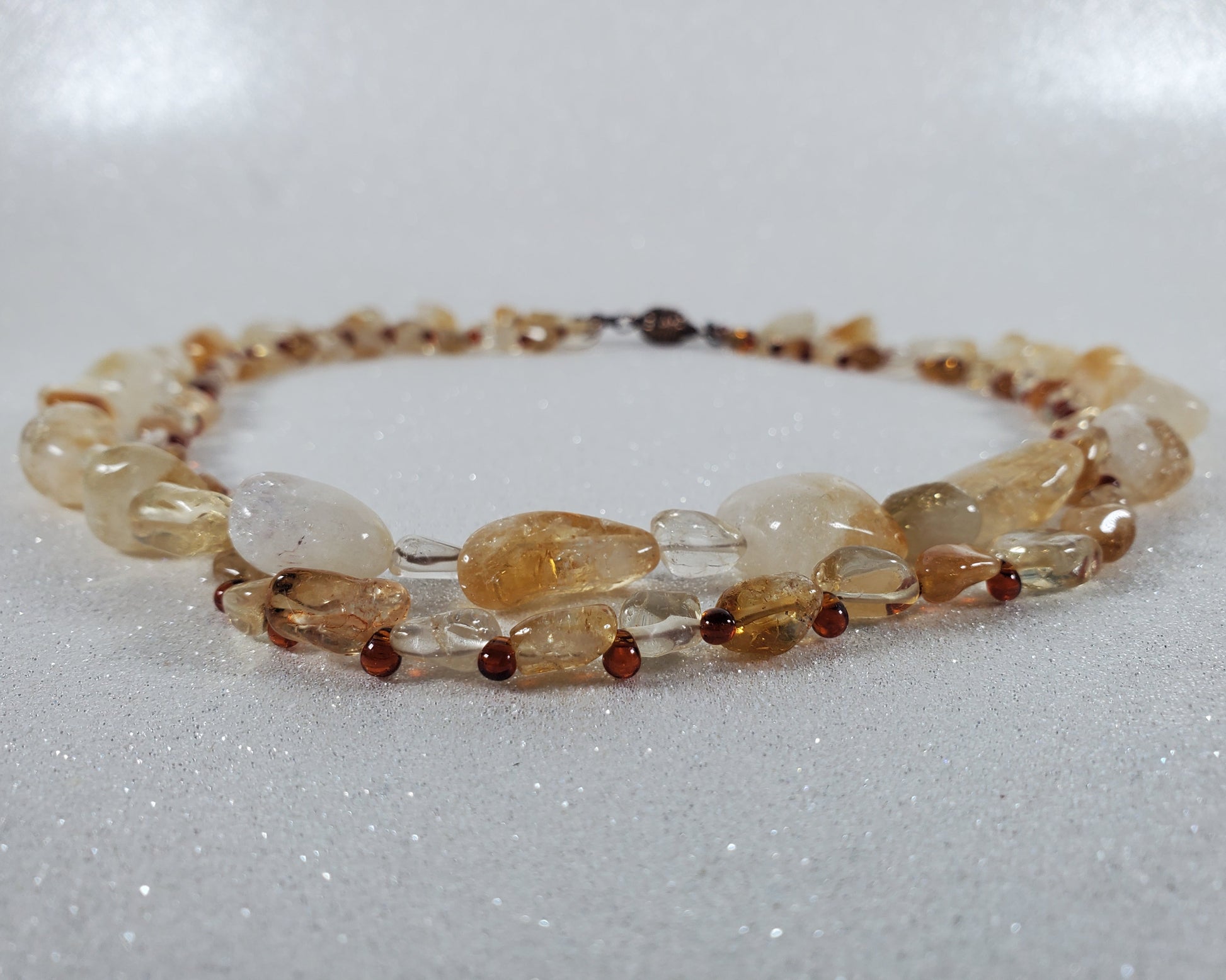 Beaded Necklace with amber and yellow beads on a white background