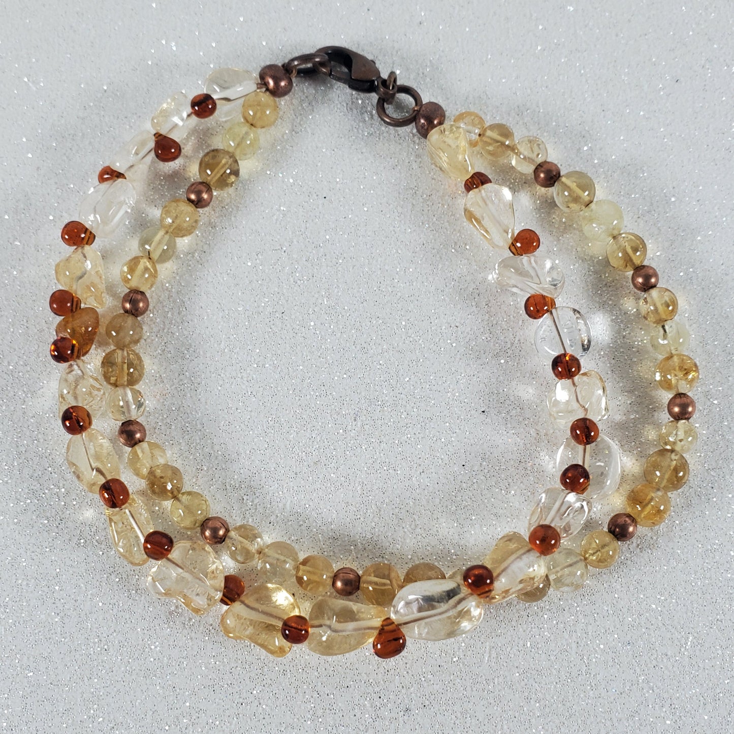 Beaded bracelet with multicolored beads on a light gray background