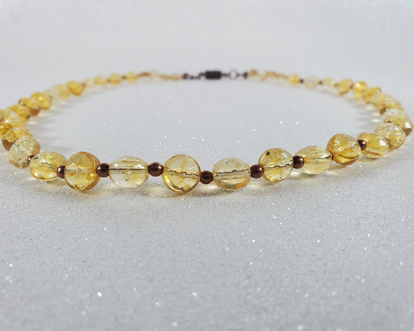 Necklace with yellow beads on a light gray background