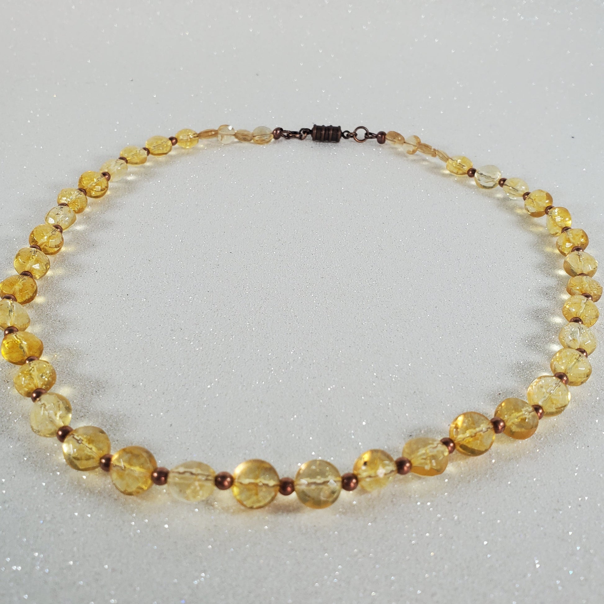 Necklace with yellow beads on a gray background