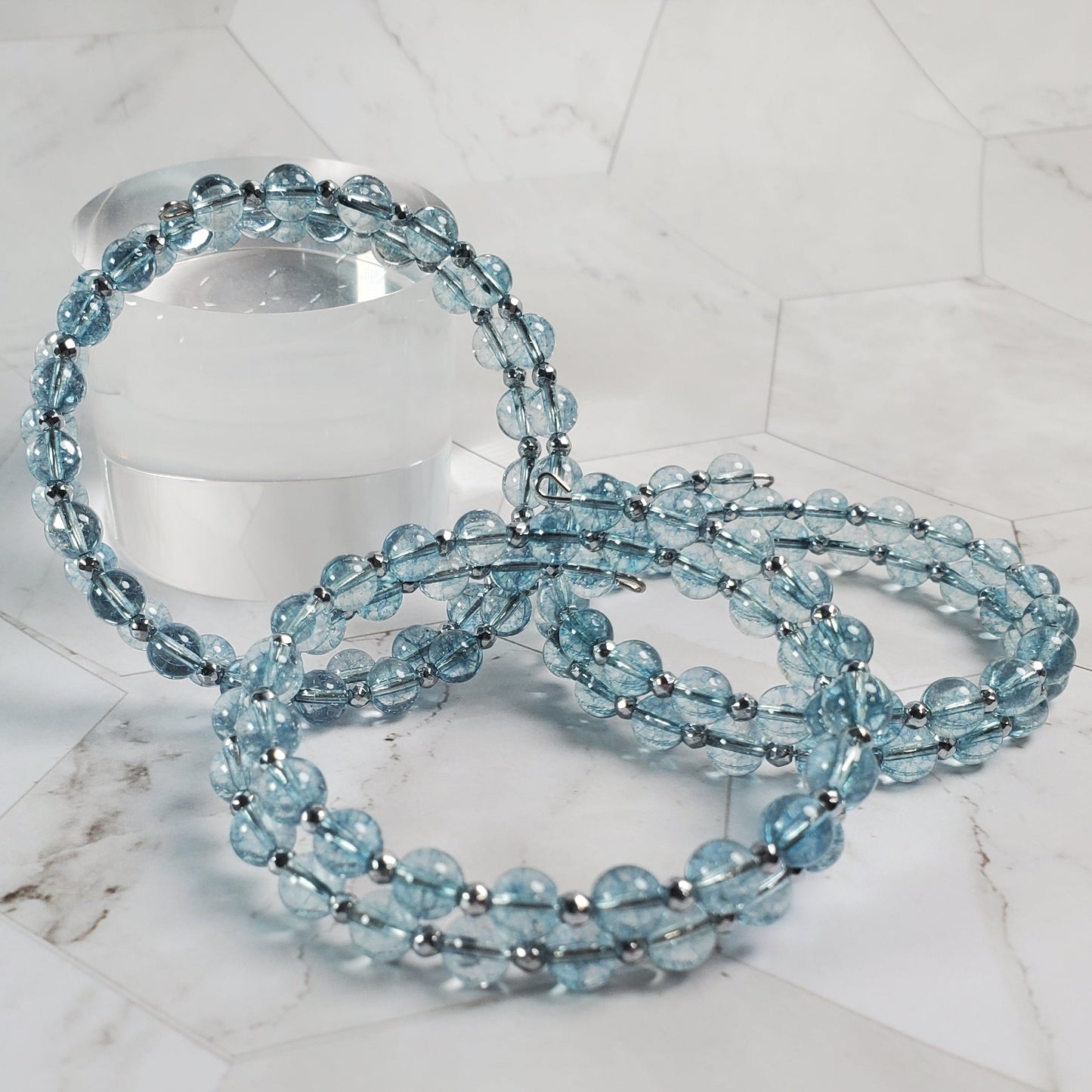 Blue beaded bracelet on a marble surface