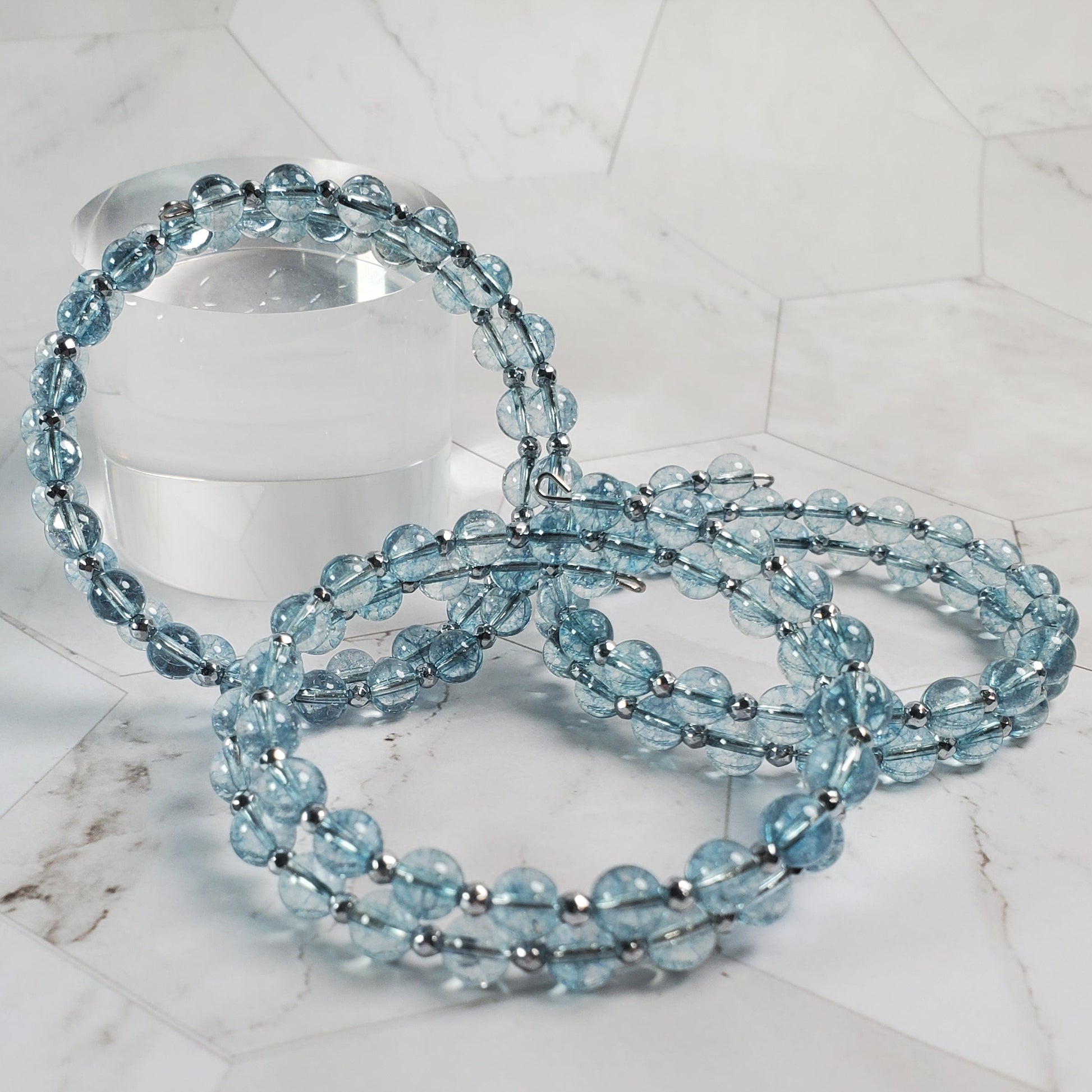 Blue beaded bracelet on a marble surface
