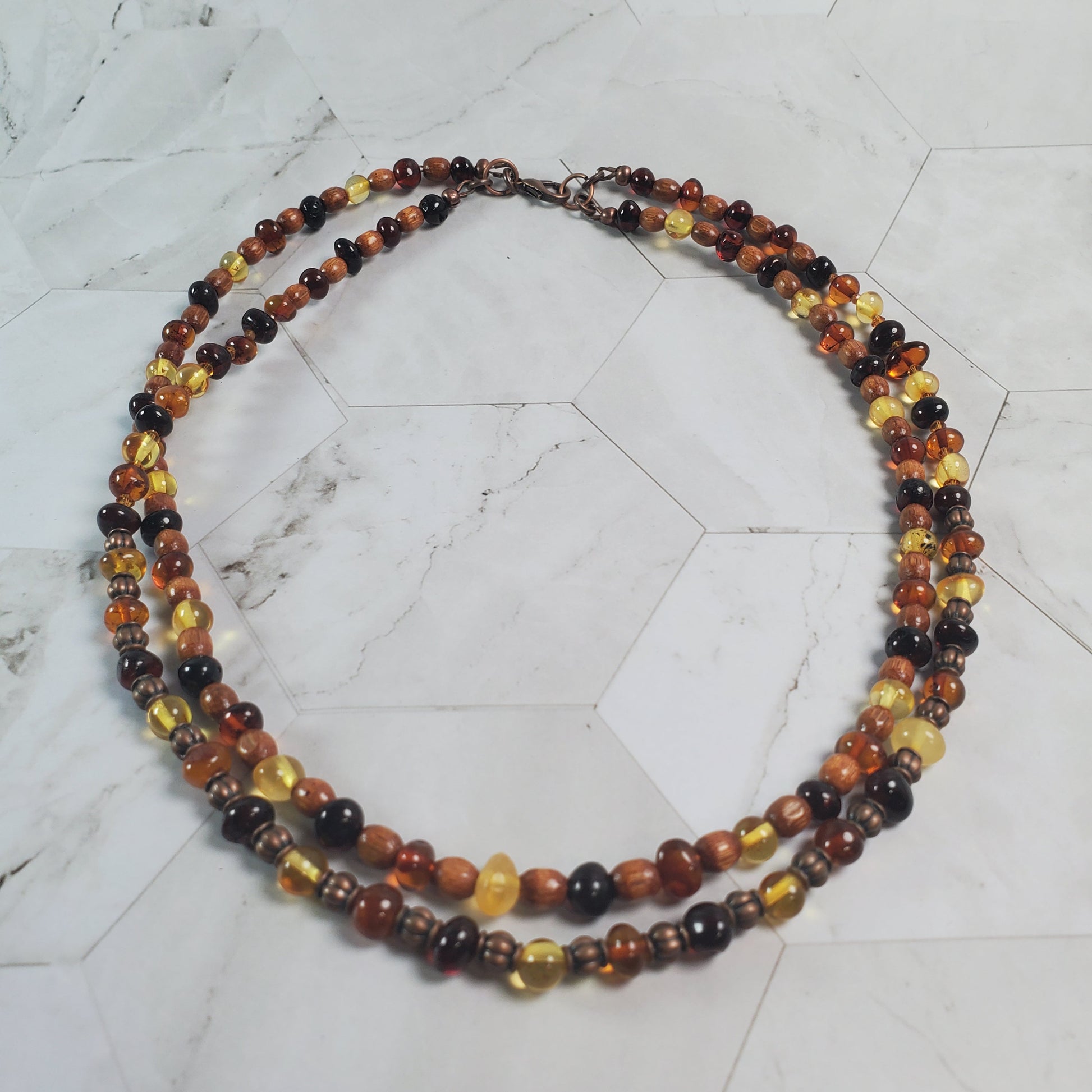 Necklace with multicolored beads on a marble surface