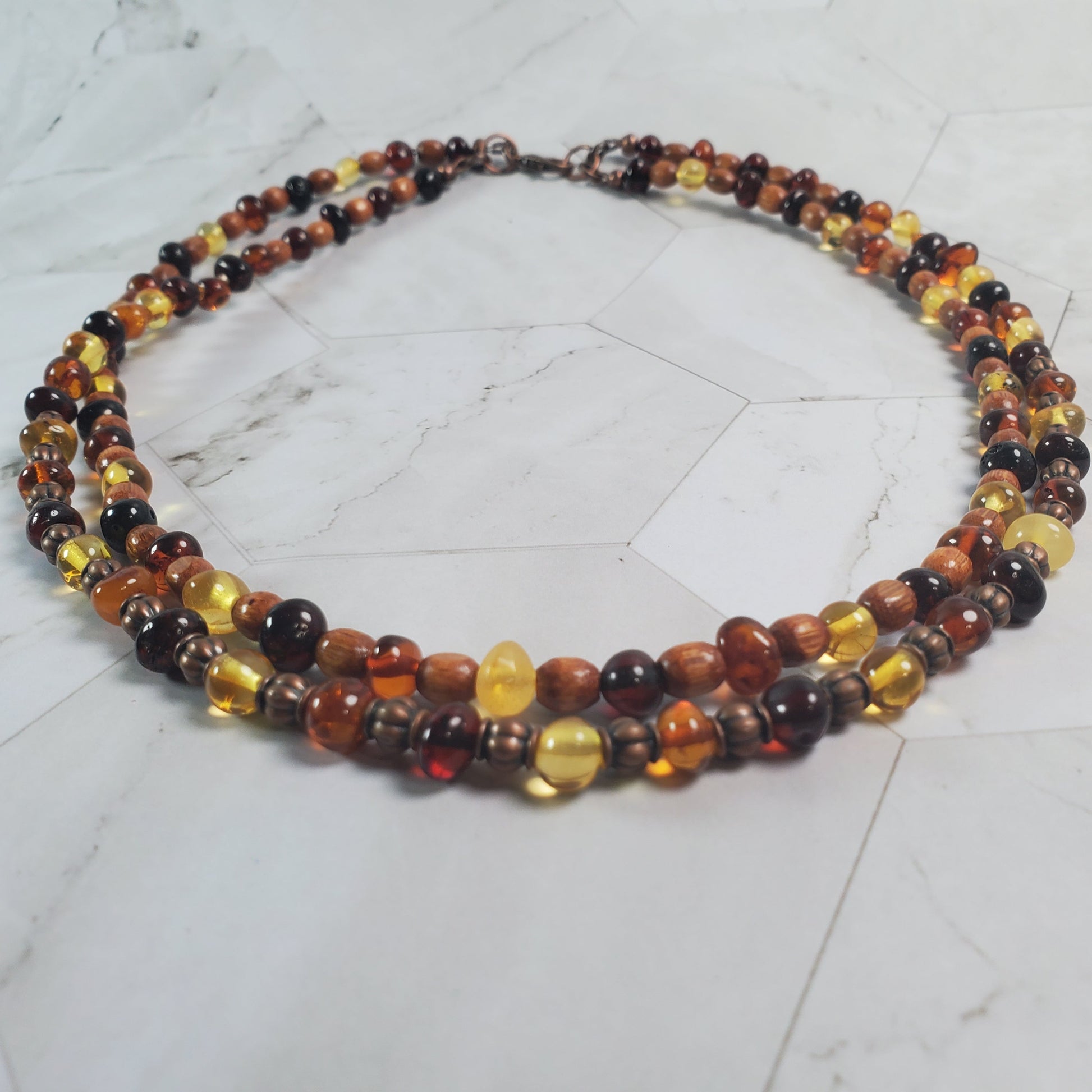 Multicolored beaded necklace on a light gray surface