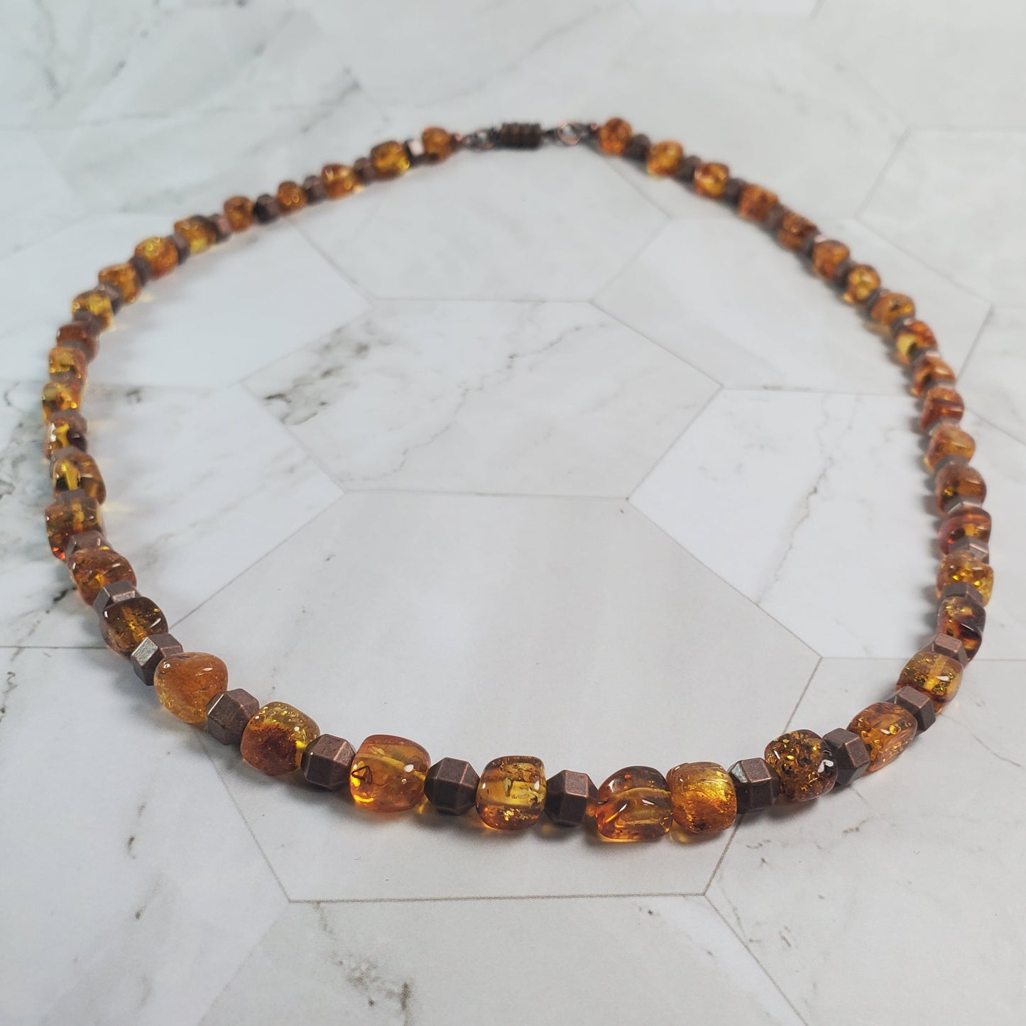Topaz-colored necklace on a marble surface