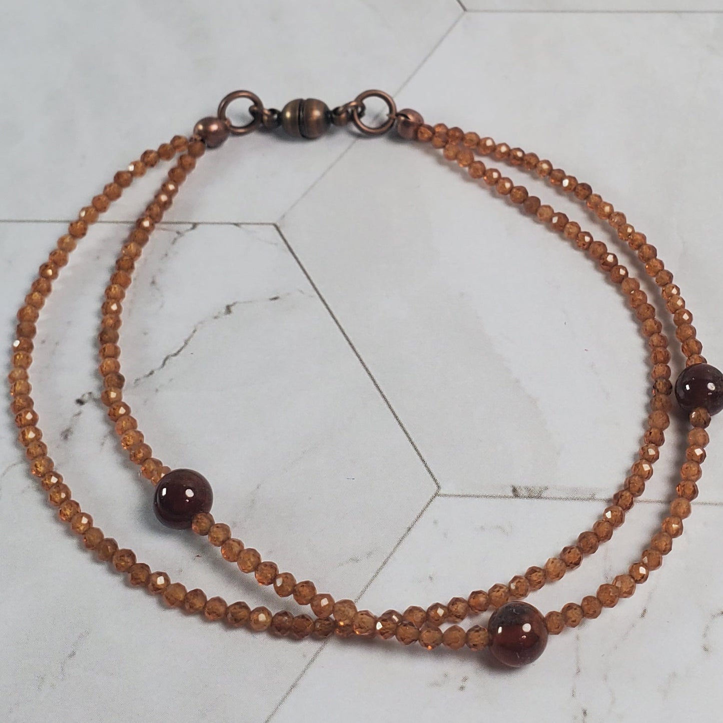 Beaded bracelet on a marble tile