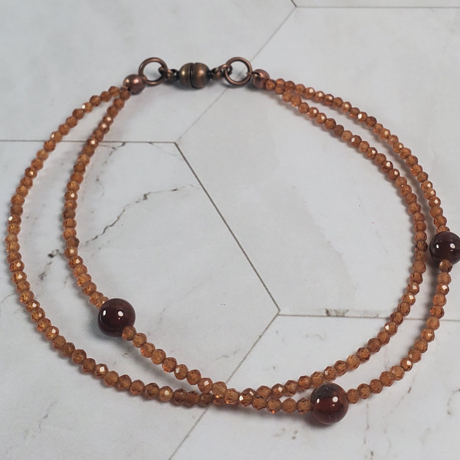 Beaded bracelet on a marble tile