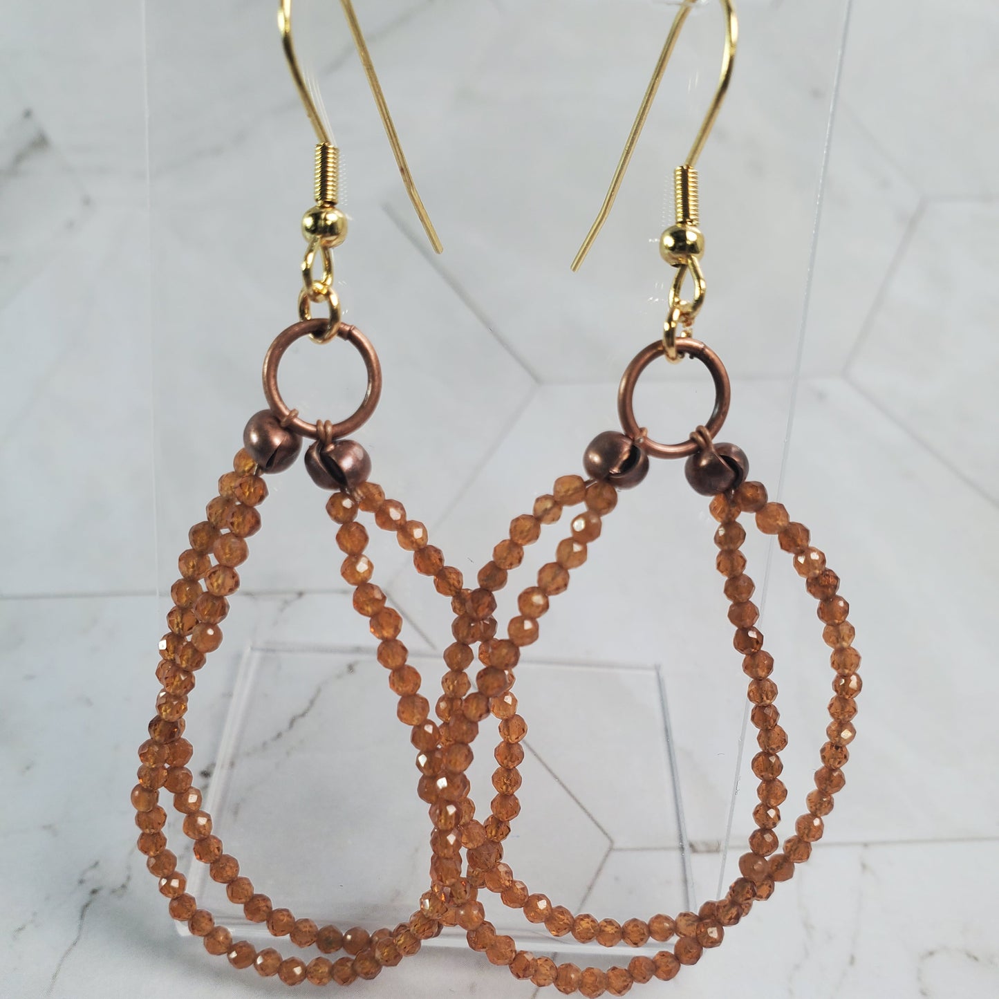 Beaded earrings on a marble surface
