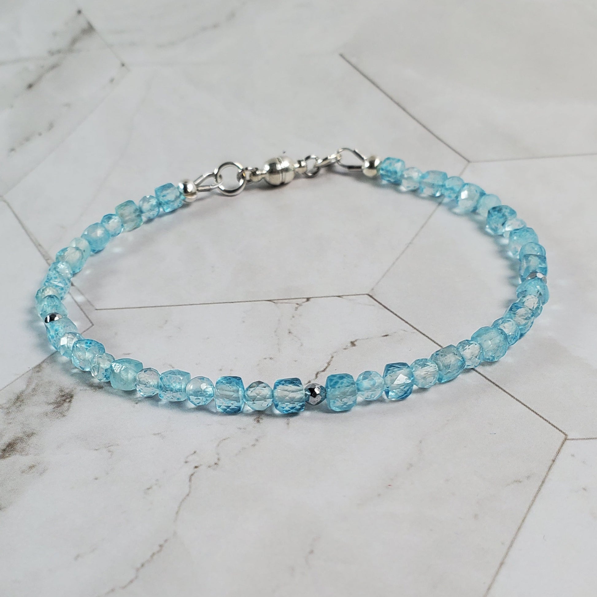 Blue beaded bracelet on a marble surface