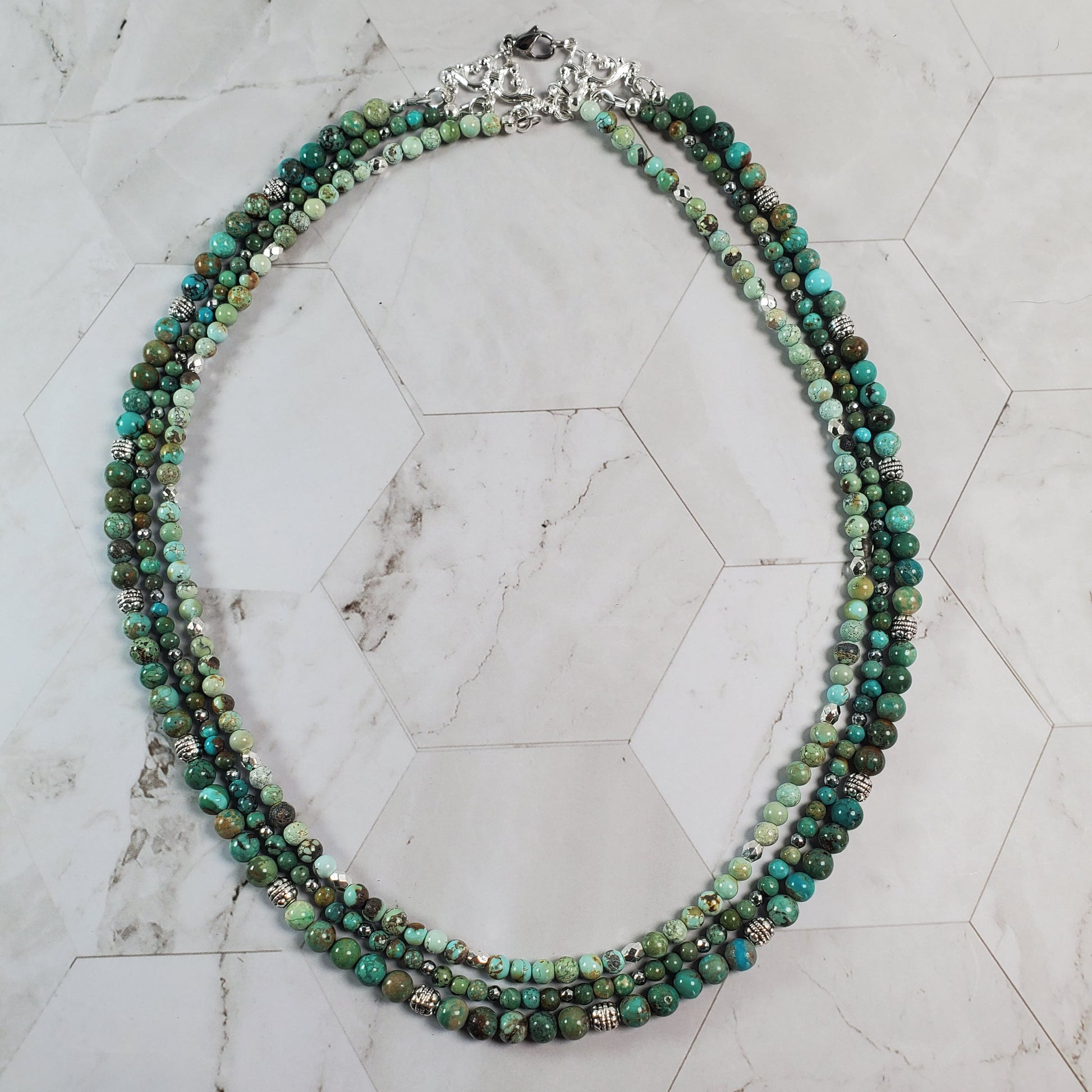 Multistrand beaded necklace on a marble surface