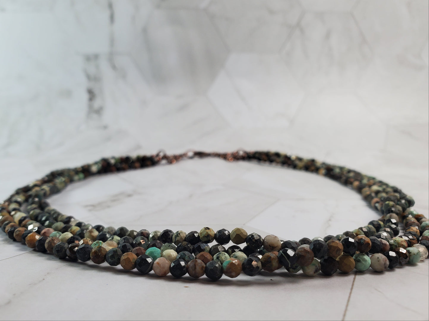 Multicolored beaded necklace on a marble surface