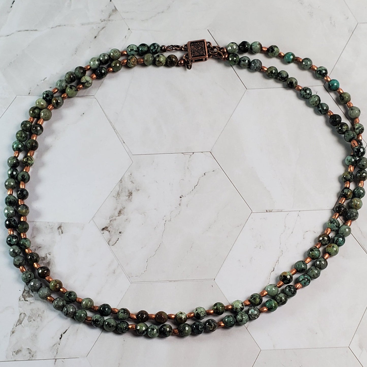 Beaded necklace on a marble surface