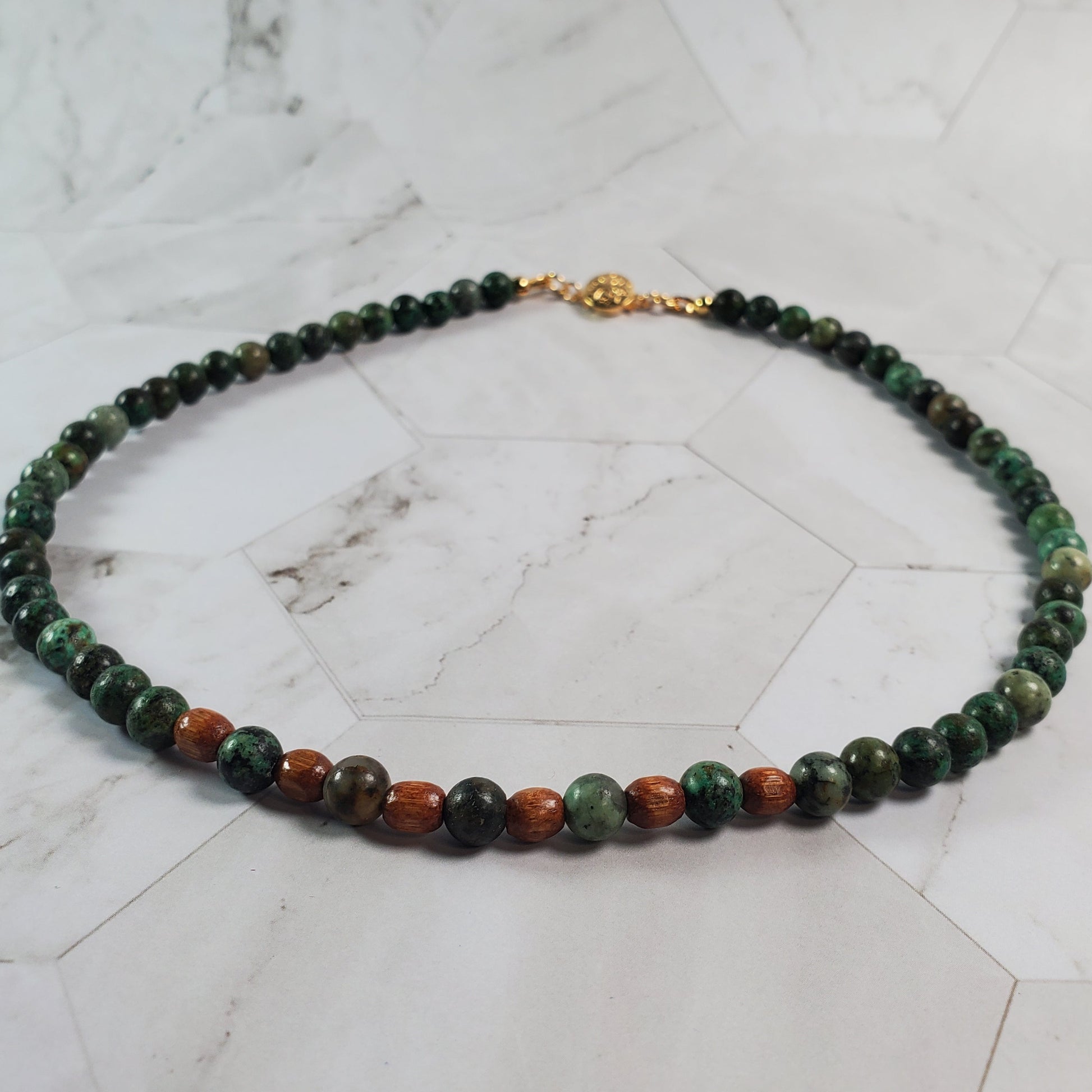 Necklace with multicolored beads on a marble surface