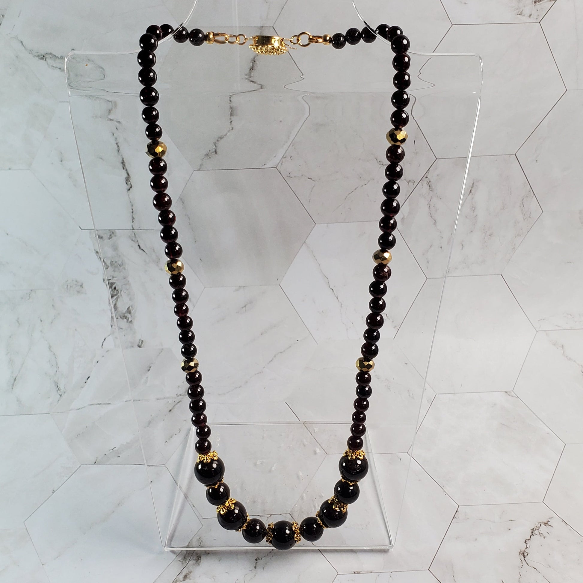 Garnet beaded necklace on a marble surface