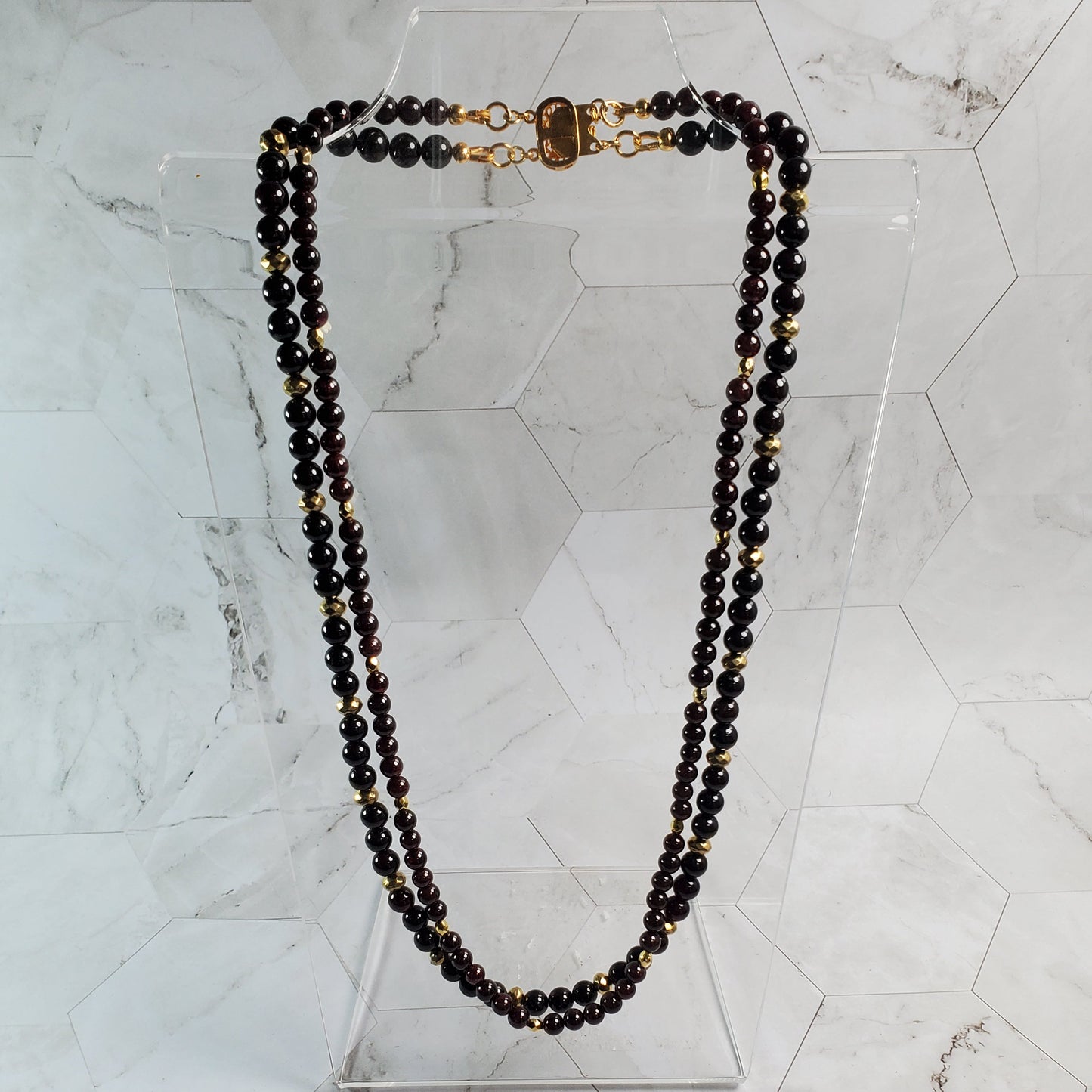 Garnet beaded necklace on a marble surface