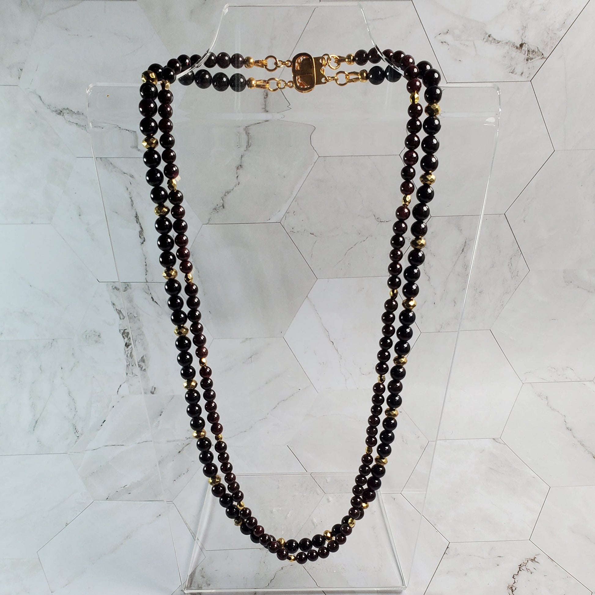 Garnet beaded necklace on a marble surface