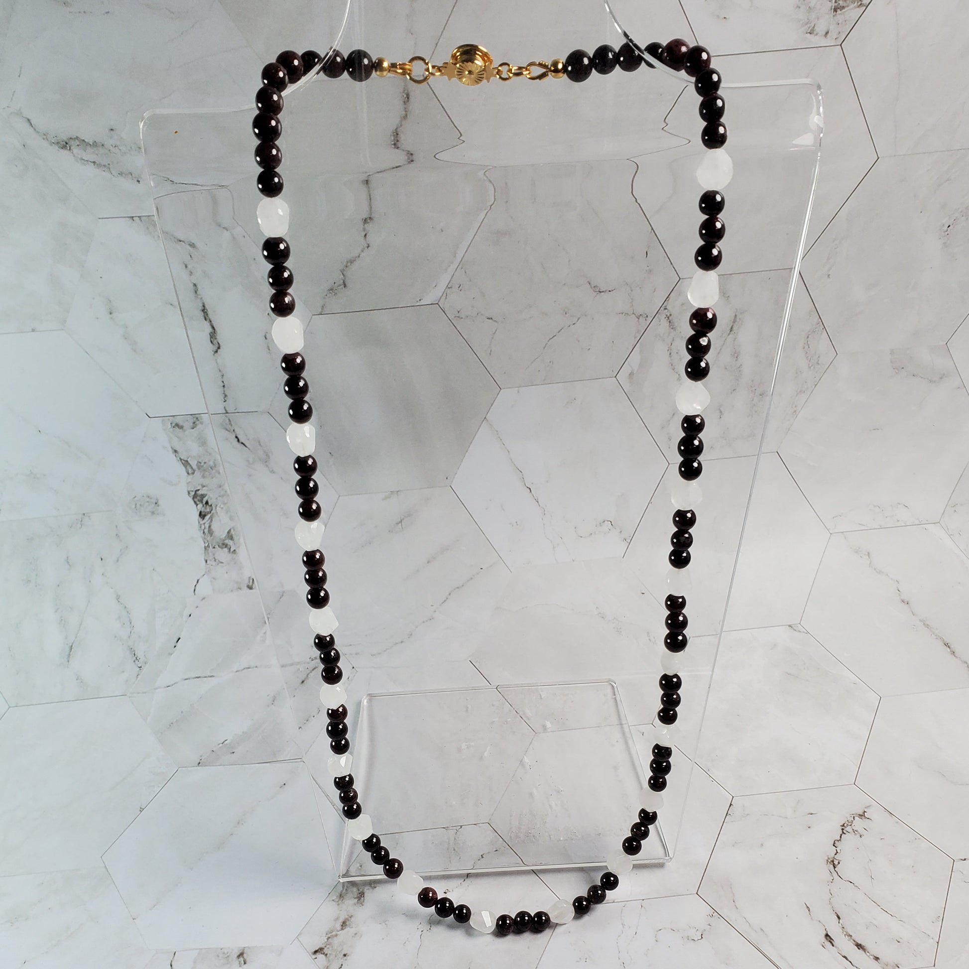 Garnet beaded necklace on a marble surface